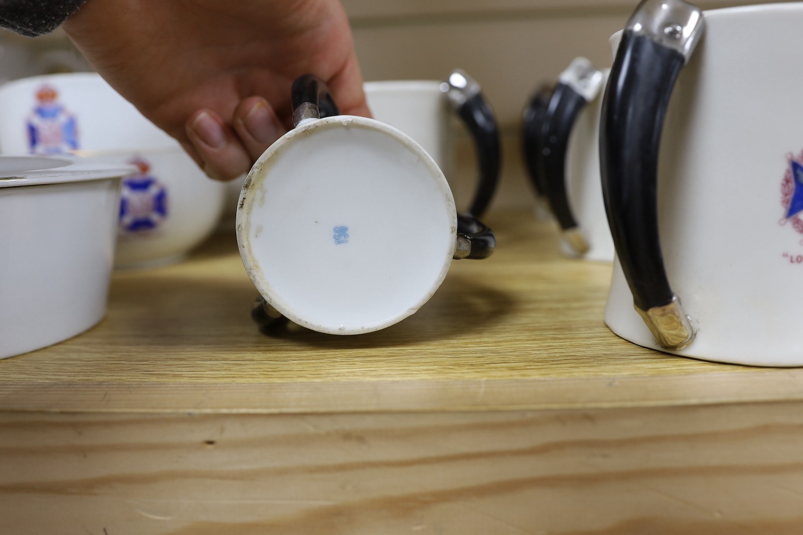 Society of Miniature Rifle Clubs - A large group of commemorative porcelain tea wares, three handled tygs and plates awarded for skill in rifle shooting, early 20th century